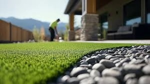 a man playing golf on artificial grass and have some bebbles along the grass