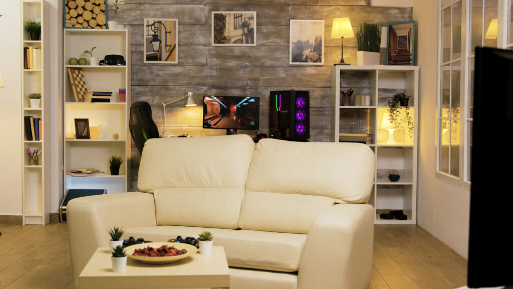 Empty room with couch in the middle and gaming computer